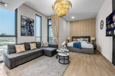 a living room with a couch and a bed at Peaceful Studio Midtown 20 mins to Expo City by Vibel in Dubai