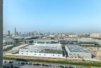 an aerial view of a factory with a city at Peaceful Studio Midtown 20 mins to Expo City by Vibel in Dubai
