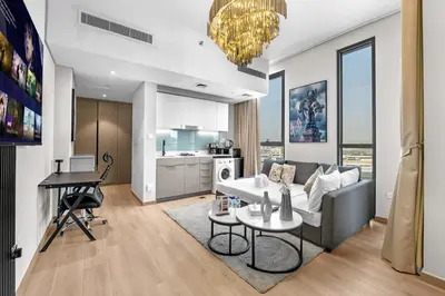 a living room with a couch and a table at Peaceful Studio Midtown 20 mins to Expo City by Vibel in Dubai