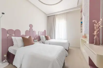 two beds in a room with pink and white at Luxury Villa with Pool and Garden 4BR The Springs in Dubai