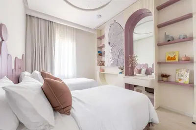 a bedroom with a white bed and a mirror at Luxury Villa with Pool and Garden 4BR The Springs in Dubai