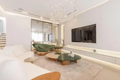 a living room with a couch and a tv at Luxury Villa with Pool and Garden 4BR The Springs in Dubai