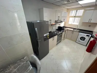 a kitchen with a refrigerator and a washer and dryer at Wonderful Rental Apartments in Dubai Silicon Oasis in Dubai