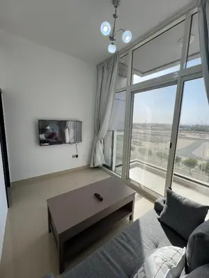 a living room with a couch and a large window at Wonderful Rental Apartments in Dubai Silicon Oasis in Dubai