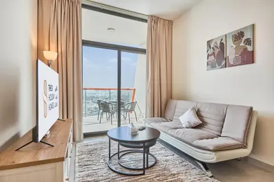 a living room with a couch and a table at One Bedroom Apartment in Binghatti Avenue by The S Holiday Homes in Dubai