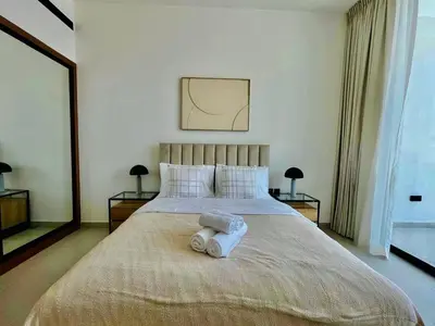 a bedroom with a bed with two pillows on it at Cozy 1br In Jvc Pool, Balcony & Free Parking in Dubai