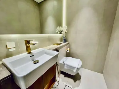 a bathroom with a sink and a toilet at Cozy 1br In Jvc Pool, Balcony & Free Parking in Dubai