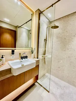 a bathroom with a sink and a shower at Canal-view Studio Jacuzzi Business Bay in Dubai