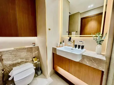 a bathroom with a white toilet and a sink at Canal-view Studio Jacuzzi Business Bay in Dubai