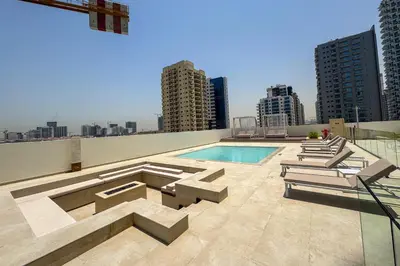 a swimming pool on the roof of a building at Elegant 1 Bedroom in Binghatti Tulip - JVC in Dubai