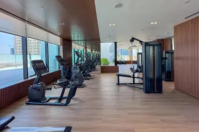 a gym with treadmills and ellipticals in a building at Elegant 1 Bedroom in Binghatti Tulip - JVC in Dubai