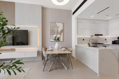 a kitchen with a table with flowers on it at Elegant 1 Bedroom in Binghatti Tulip - JVC in Dubai