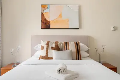 a bedroom with a white bed with towels on it at GuestReady - Premium stay in JBR walk in Dubai