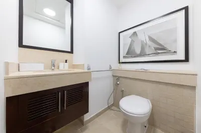 a bathroom with a toilet and a sink at Burj and Fountain view 3BR plus maids room in Dubai