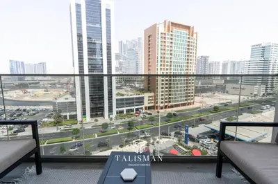 a balcony with a view of a city with tall buildings at Canal View Studio MAG 318 in Dubai
