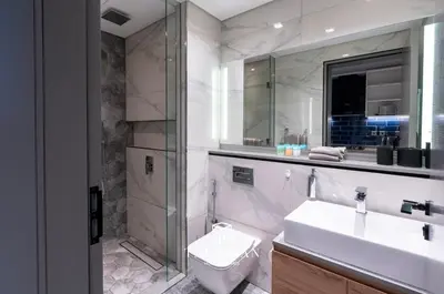a bathroom with a toilet and a sink and a shower at Canal View Studio MAG 318 in Dubai