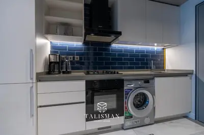 a kitchen with a washer and dryer in a room at Canal View Studio MAG 318 in Dubai