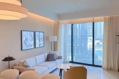 a living room with a white couch and a large window at ADDRESS Residences Opera 2BR Tower 1 - EPIC 30th floor Burj Khalifa view byBLCK with DXB AIRPORT VIP Shuttle option in Dubai