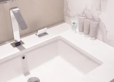 a bathroom with a white sink with a mirror at ADDRESS Residences Opera 2BR Tower 1 - EPIC 30th floor Burj Khalifa view byBLCK with DXB AIRPORT VIP Shuttle option in Dubai