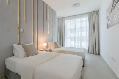a hotel room with two beds and a window at 3BR Apartment in the heart of Dubai Marina in Dubai