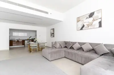a living room with a couch and a table at 3BR Apartment in the heart of Dubai Marina in Dubai