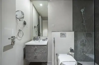 a bathroom with a toilet and a sink and a shower at Modern 1BR in Avanti with Pool & Gym in Dubai
