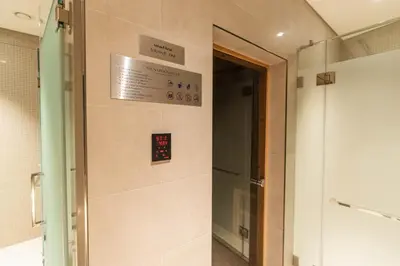 a elevator in a bathroom with a sign on the wall at Sobha Waves Grande Big 1BR apt Burj Khalifa views! in Dubai