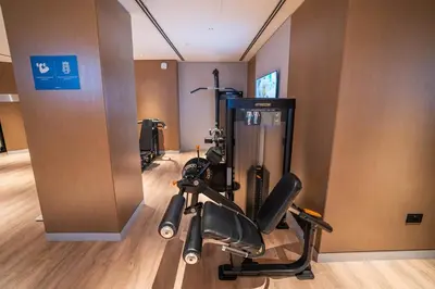 a gym with a exercise bike in a room at Sobha Waves Grande Big 1BR apt Burj Khalifa views! in Dubai