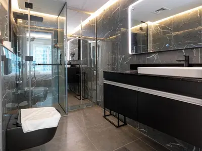 a bathroom with a glass shower and a sink at Cozy and Uniquely Furnished One Bedroom Dubai Marina in Dubai