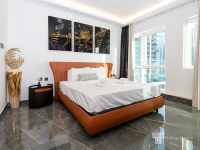 a bedroom with a large bed in a room at Cozy and Uniquely Furnished One Bedroom Dubai Marina in Dubai