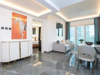 a living room with a table and chairs and a dining room at Cozy and Uniquely Furnished One Bedroom Dubai Marina in Dubai