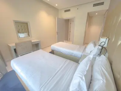 a room with two beds in a hospital room at Damac Voleo - Blue Ocean Holiday Homes in Dubai