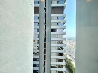 an aerial view of a tall building with a beach at Homes2Retreat - Luxury Finishes with Full Skyline View in Dubai