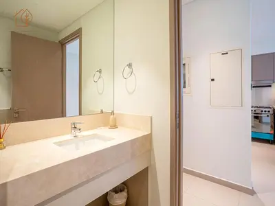 a bathroom with a sink and a mirror at Burj Views Elegance from 3 Bedroom Apartment 214-A1-3 in Dubai