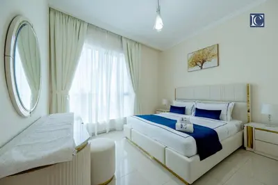 a bedroom with a large bed and a window at Luxury Escapes- Elegant Marina View Bay Central 3BR and Maids Room- single bed in Dubai