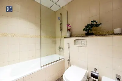 a bathroom with a toilet and a tub and a sink at Luxury Escapes- Elegant Marina View Bay Central 3BR and Maids Room- single bed in Dubai