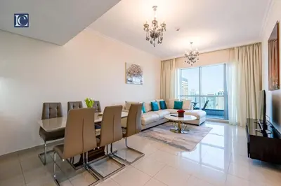 a living room with a dining table and a couch at Luxury Escapes- Elegant Marina View Bay Central 3BR and Maids Room- single bed in Dubai