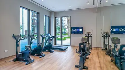 a gym with several treadmills and elliptical machines at Resort-Style 1BR in Dubai Creek Harbour -1AB01 in Dubai