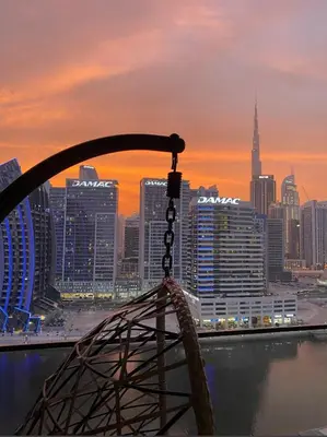 a view of a city skyline at sunset at Studio With Jaw-Dropping Canal And Burj Views in Dubai