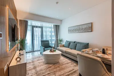 a living room with a couch and a table at Bright & Elegant Saven The Palm 1bhk Apartment in Dubai