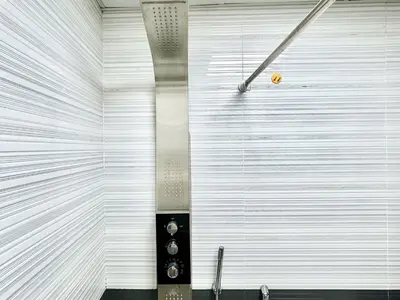a room with a white wall with a machine at Homes2Retreat - Glamz Haven Stylish Studio with Balcony in Dubai