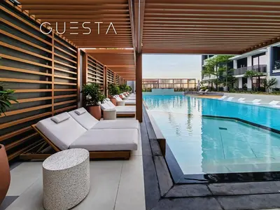 a hotel swimming pool with couches and a swimming pool at Hamilton House, Jumeirah Village Circle in Dubai