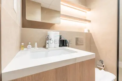 a bathroom with a white sink in a room at New Studio Close to Town Square Park, Short Drive to Al Qudra Lake, Liva Apartments by Deluxe Holiday Homes in Dubai
