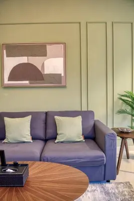 a living room with a purple couch and a table at Elegant Cozy Marina Home in Dubai