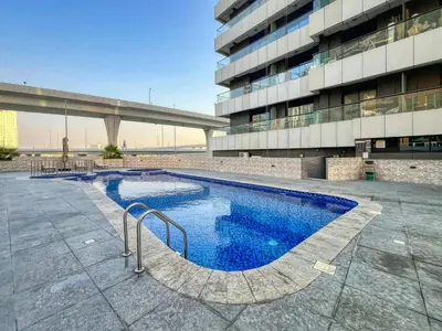 a large swimming pool in front of a building at Elegant Cozy Marina Home in Dubai