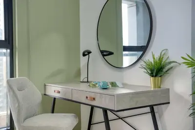 a dressing table with a mirror and a chair at Elegant Cozy Marina Home in Dubai