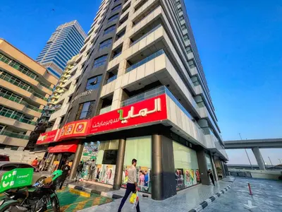 a man walking in front of a building at Elegant Cozy Marina Home in Dubai