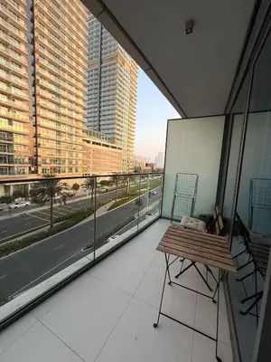 a balcony with a bench and a view of a city at Blue Horizon Living in Dubai