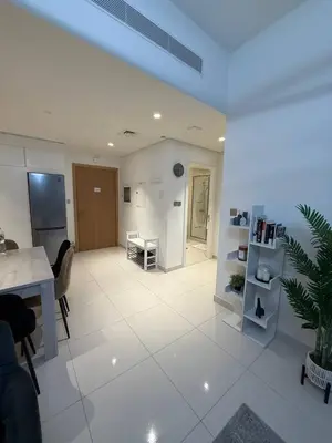 a large living room with a table and a kitchen at Blue Horizon Living in Dubai