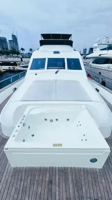 a white boat is docked on a dock at Riviera Leisure Yachts Dubai in Dubai